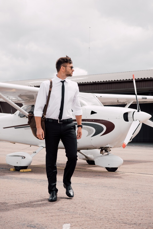 Aspiring pilot beside a training aircraft